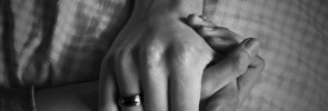 black and white photo of two people with hands clasped - how to help an addict you care about - no more enabling - nomoreenabling.com